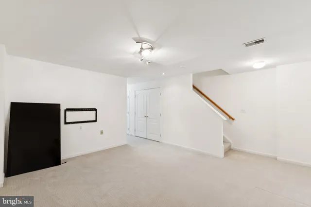 a view of an empty room with a ceiling fan