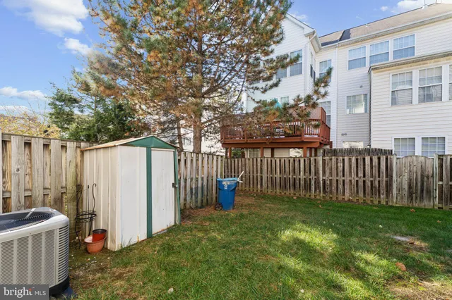 a view of a house with a small yard and wooden fence