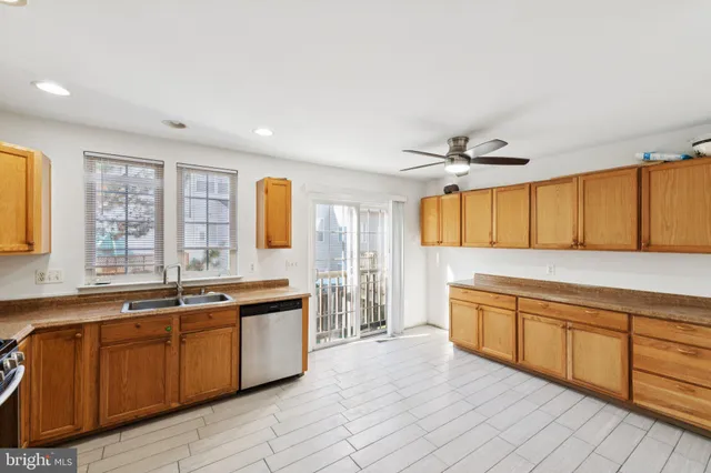 a large kitchen with stainless steel appliances granite countertop a sink and cabinets