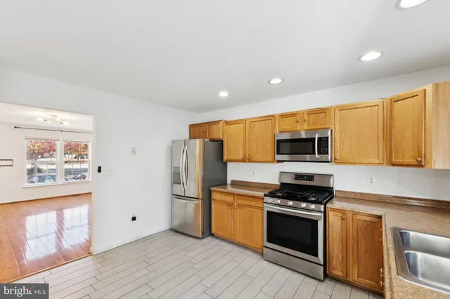 a kitchen with stainless steel appliances a refrigerator stove and microwave