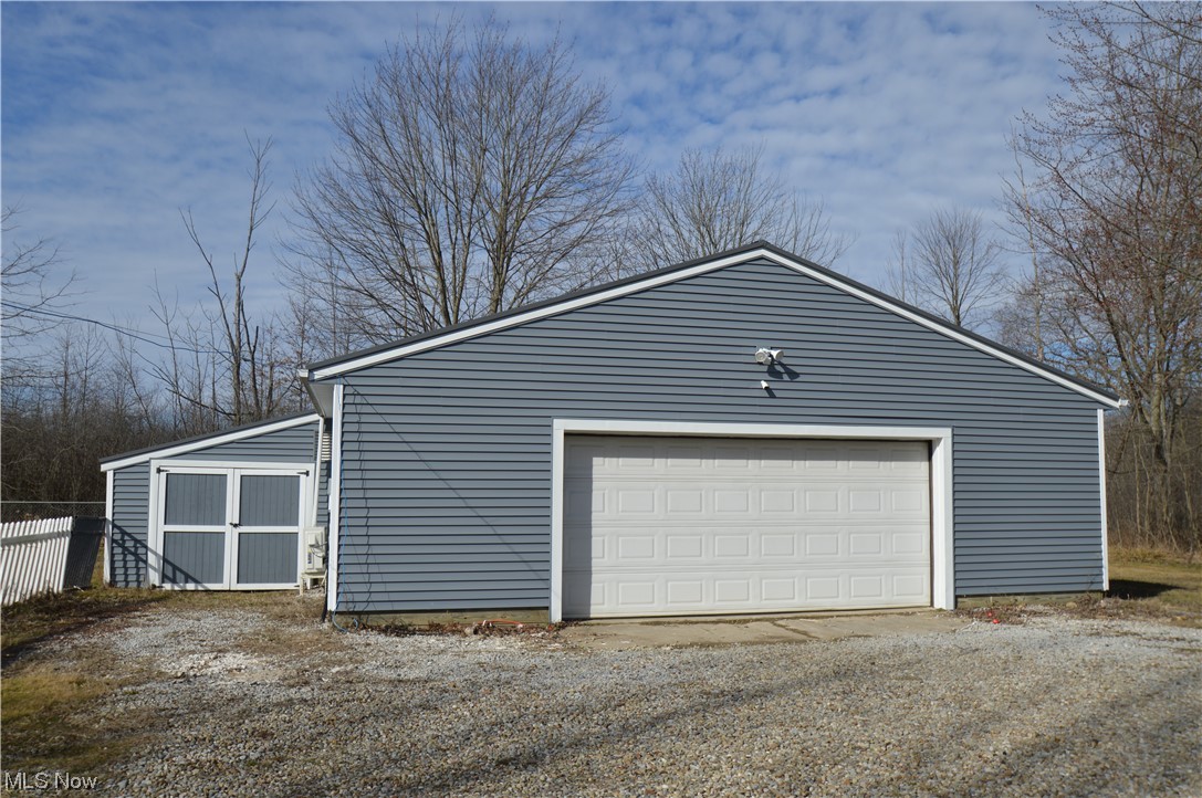 Outbuilding with heated workspace, 2+ car garage, and attached storage shed.