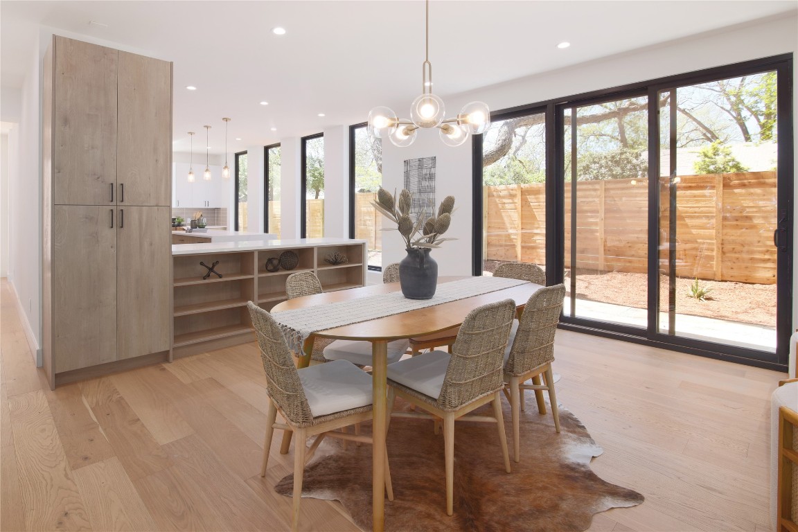 2401 Willow Street Austin, TX 78702 - Photo 11 of 38 a dining room with furniture large windows and a chandelier