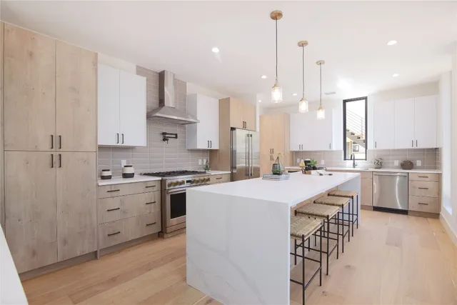 a kitchen with white cabinets and white appliances