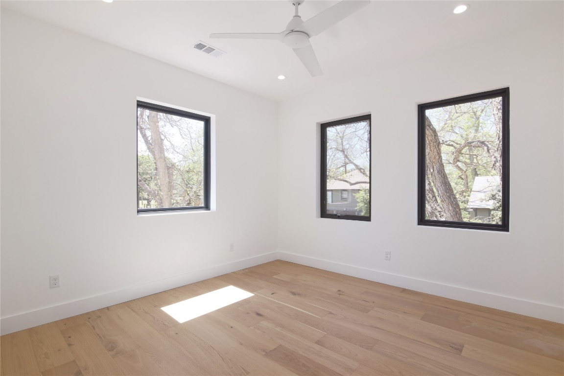 2401 Willow Street Austin, TX 78702 - Photo 17 of 38 a view of an empty room with wooden floor and a window