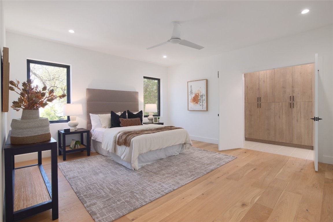 2401 Willow Street Austin, TX 78702 - Photo 19 of 38 a bedroom with a large bed lamps and table