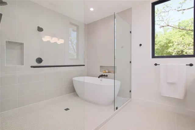 a bathroom with a bathtub and shower