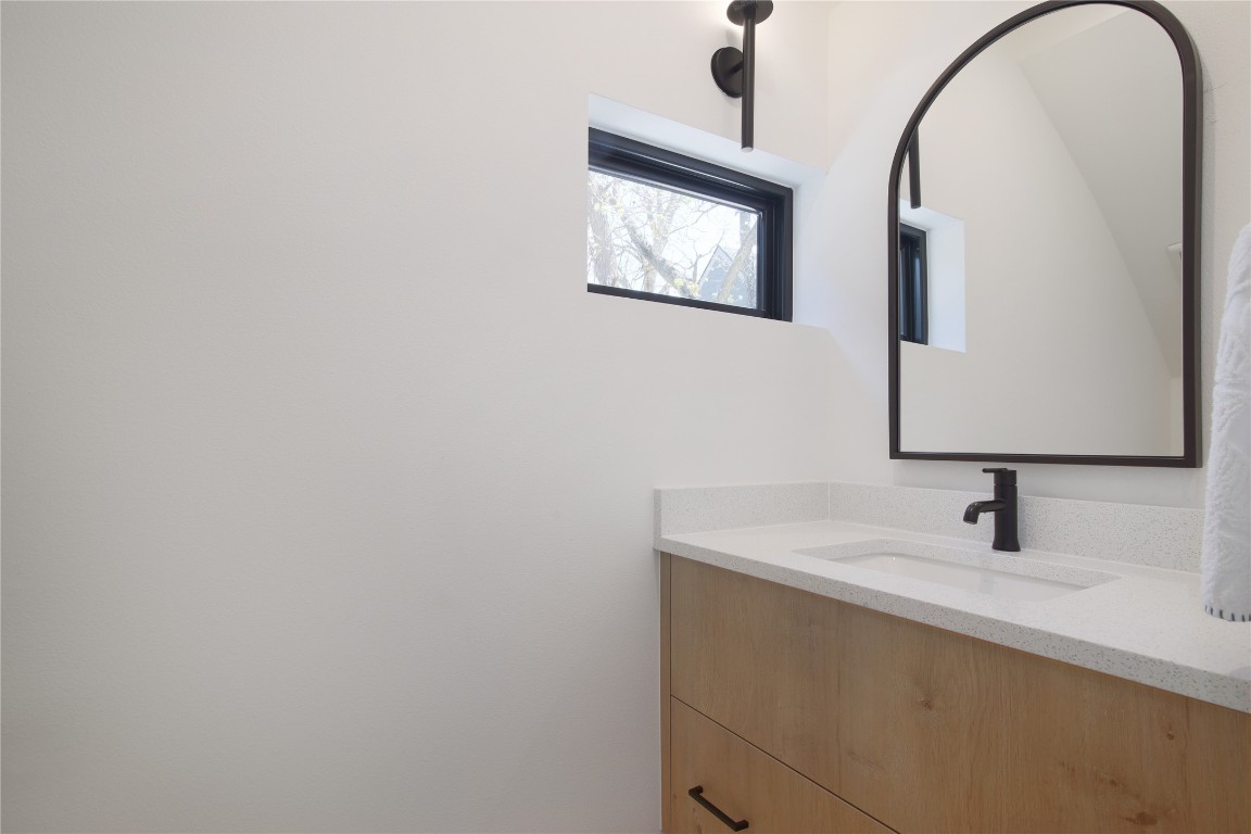 2401 Willow Street Austin, TX 78702 - Photo 28 of 38 a bathroom with a sink and a mirror