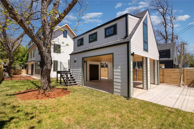 a view of a house with backyard and sitting area