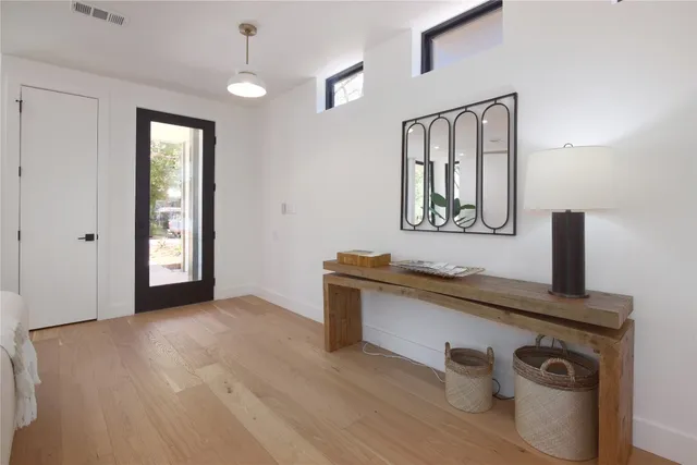 a view of an entryway with wooden floor