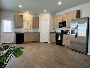 13309 Riding Drive Manor, TX 78653 - Photo 6 of 34 Kitchen featuring black appliances, dark wood-style flooring, and recessed lighting