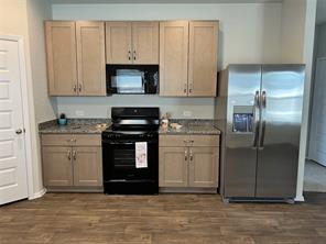 13309 Riding Drive Manor, TX 78653 - Photo 7 of 34 Kitchen includes stainless steel double door refrigerator with ice maker and filtered water dispenser.