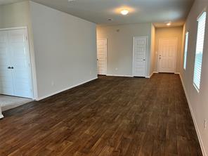 13309 Riding Drive Manor, TX 78653 - Photo 9 of 34 Unfurnished living room with dark wood finished floors
