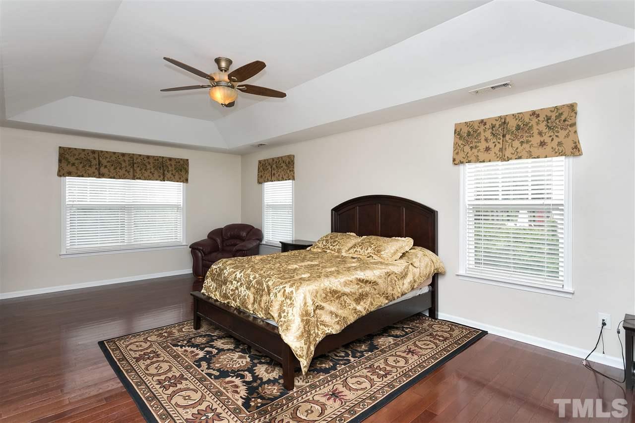 119 Key Biscayne Court Raleigh, NC 27603 - Photo 15 of 24 a bedroom with a large bed and a window