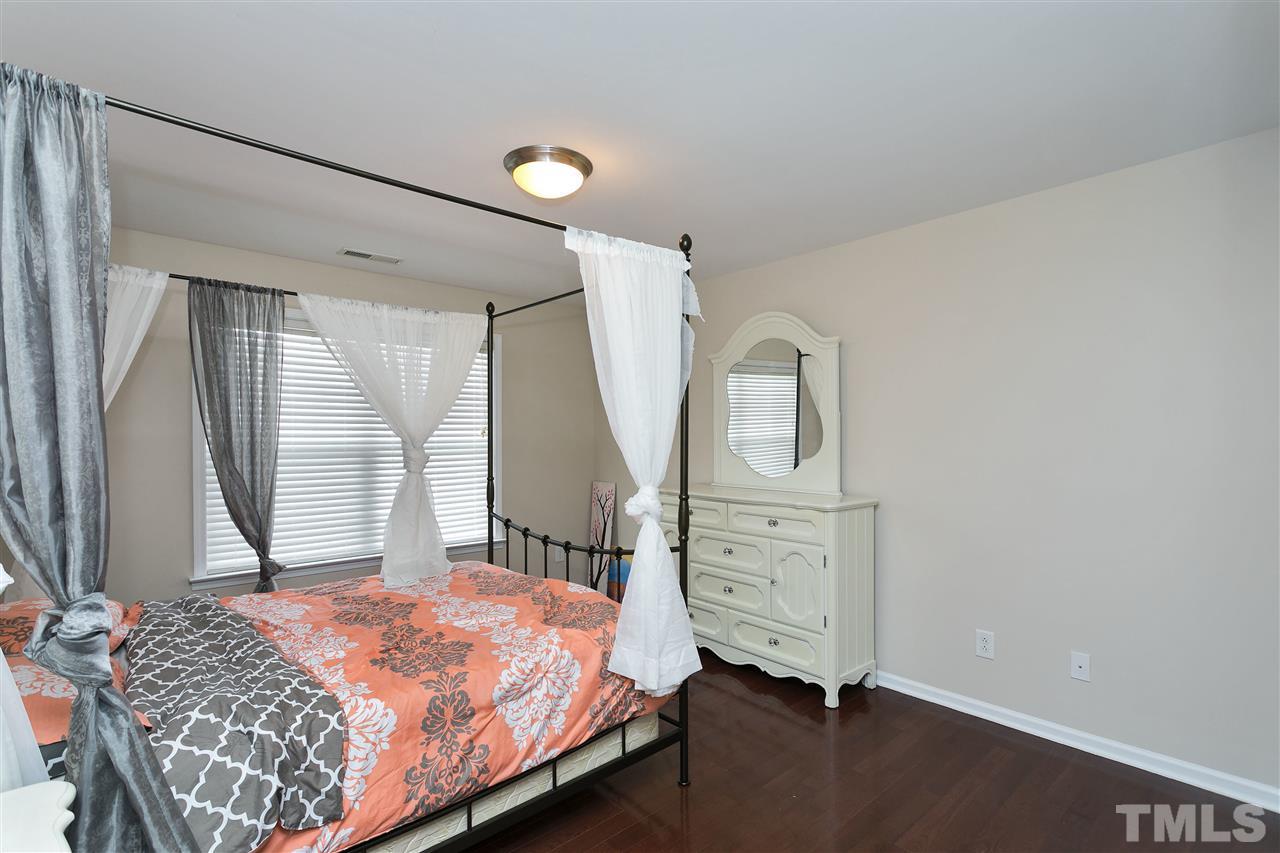 119 Key Biscayne Court Raleigh, NC 27603 - Photo 16 of 24 a bedroom with a bed and a mirror on the dresser