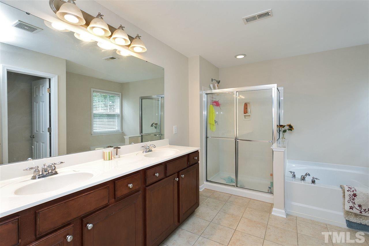 119 Key Biscayne Court Raleigh, NC 27603 - Photo 17 of 24 a bathroom with a double vanity sink mirror and shower