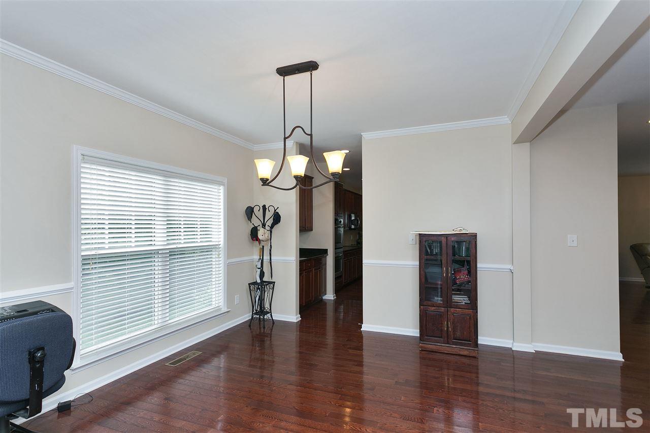 119 Key Biscayne Court Raleigh, NC 27603 - Photo 5 of 24 a view of a livingroom with a window and wooden floor