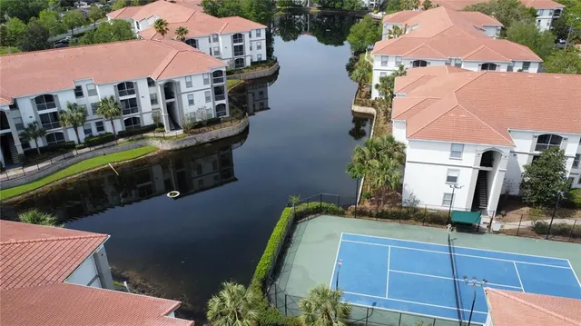 an aerial view of a house with outdoor space and lake view