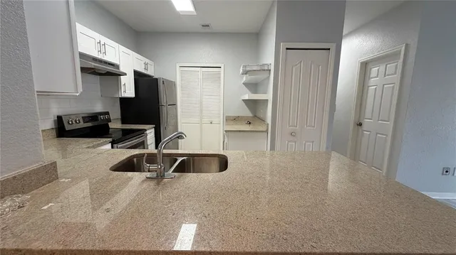 a view of a livingroom with workspace and a window