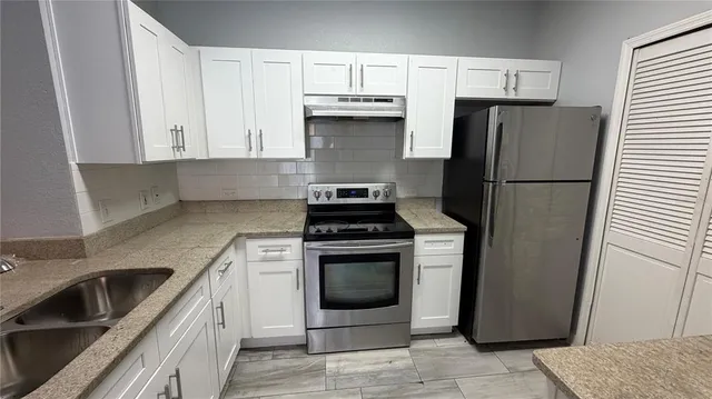 a kitchen with a stove microwave and refrigerator
