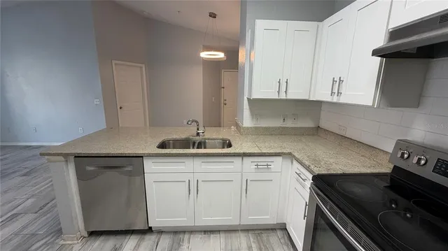 a kitchen with a sink stove and cabinets