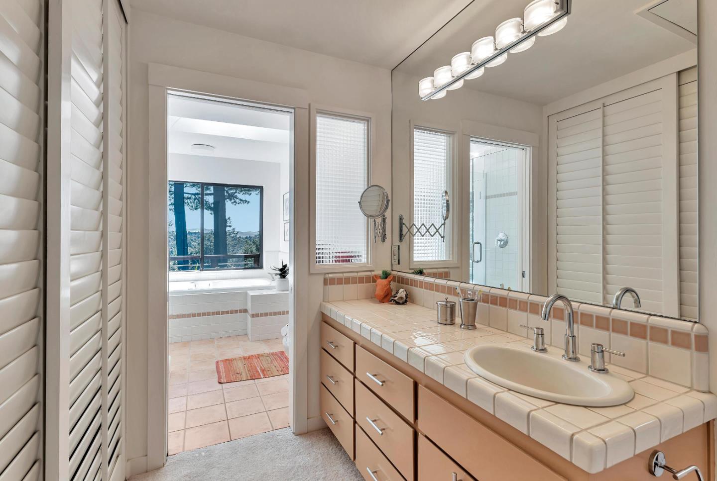 19170 Old Vineyard Road Los Gatos, CA 95033 - Photo 28 of 52 a bathroom with a granite countertop double vanity sink and a mirror