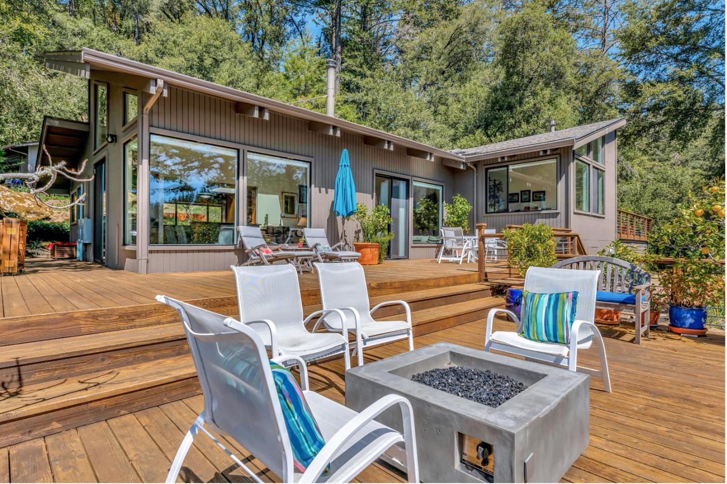 19170 Old Vineyard Road Los Gatos, CA 95033 - Photo 37 of 52 a view of a patio with couches table and chairs with wooden floor and fence