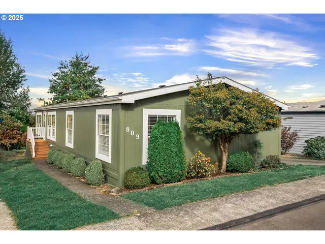 a front view of house with a garden