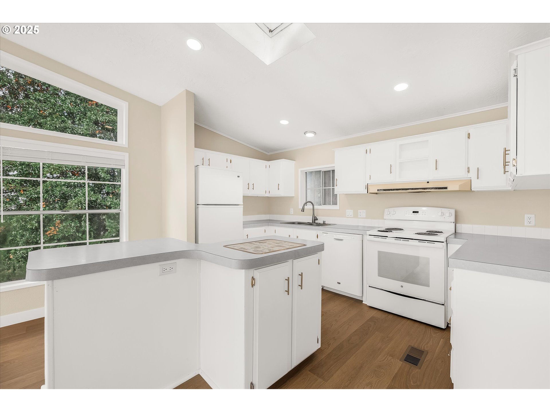 809 Southwest Crestview Way Troutdale, OR 97060 - Photo 11 of 40 a kitchen with white cabinets appliances and a window
