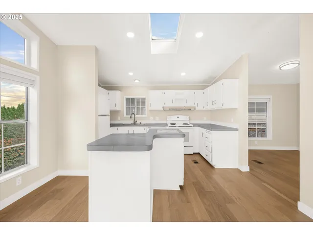 a kitchen with a refrigerator and a sink