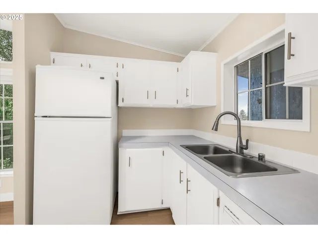 a kitchen with refrigerator and cabinets