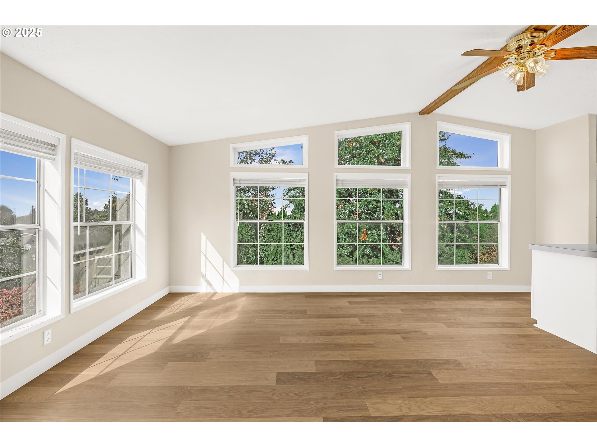 809 Southwest Crestview Way Troutdale, OR 97060 - Photo 14 of 40 a view of an empty room with wooden floor and windows
