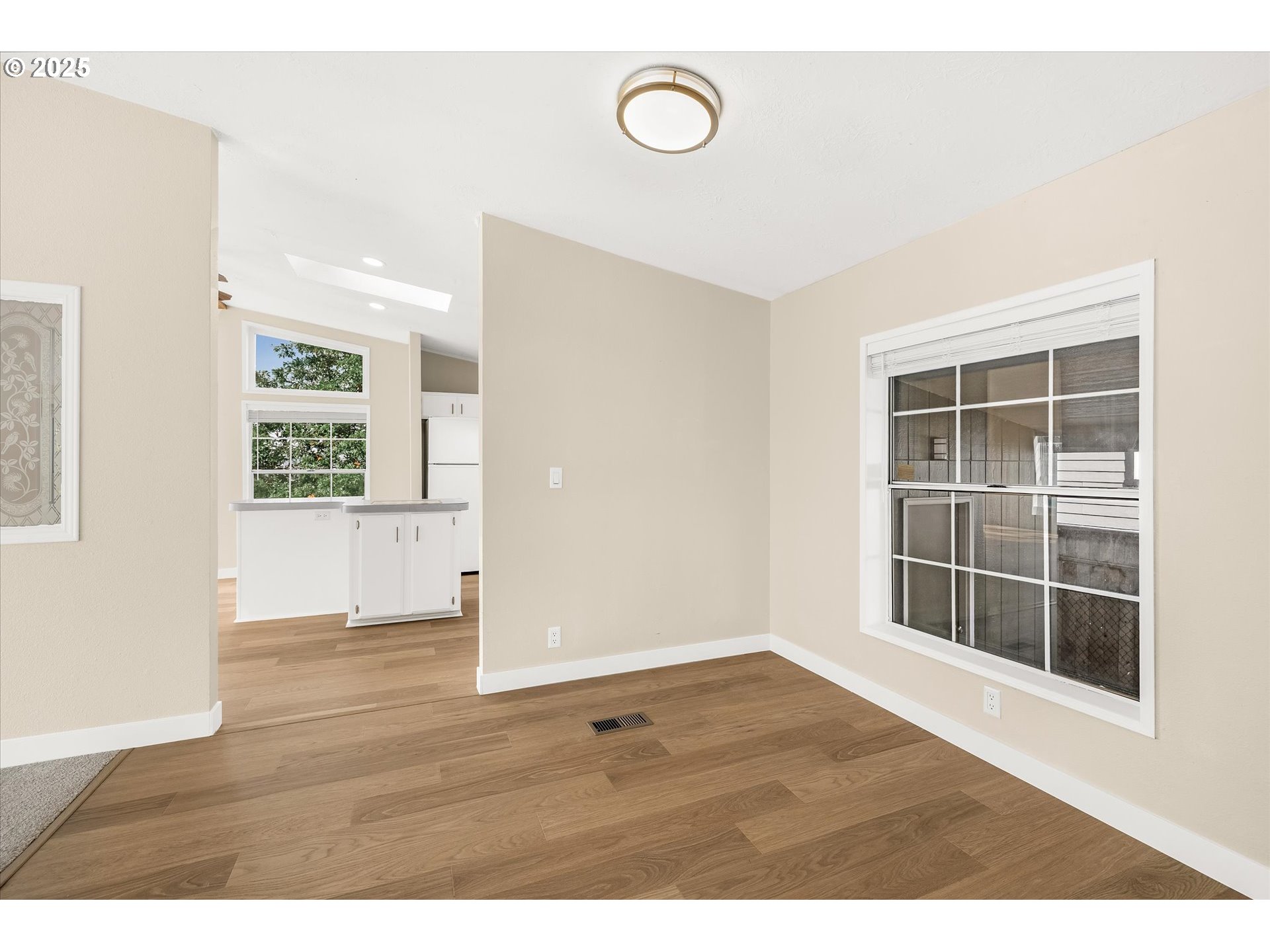 809 Southwest Crestview Way Troutdale, OR 97060 - Photo 15 of 40 a view of an empty room with wooden floor and windows