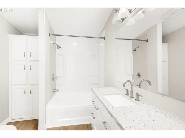 a bathroom with a granite countertop sink mirror and a