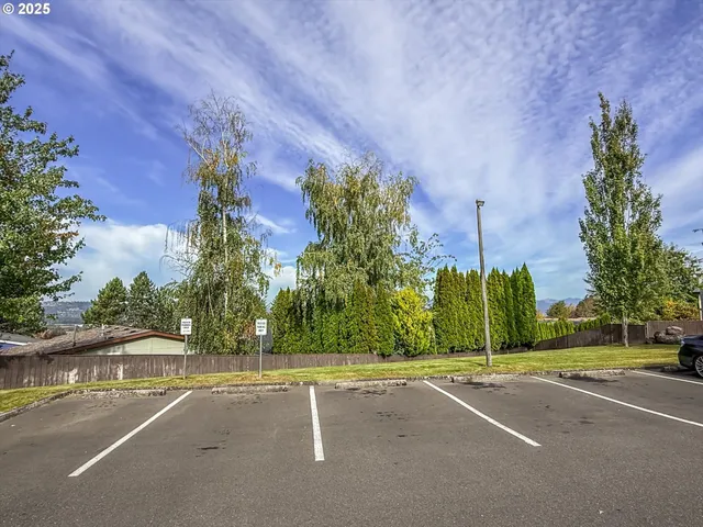 a view of a balcony with a floor to ceiling window and wooden fence