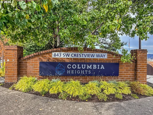 a sign that is sitting in front of flowers