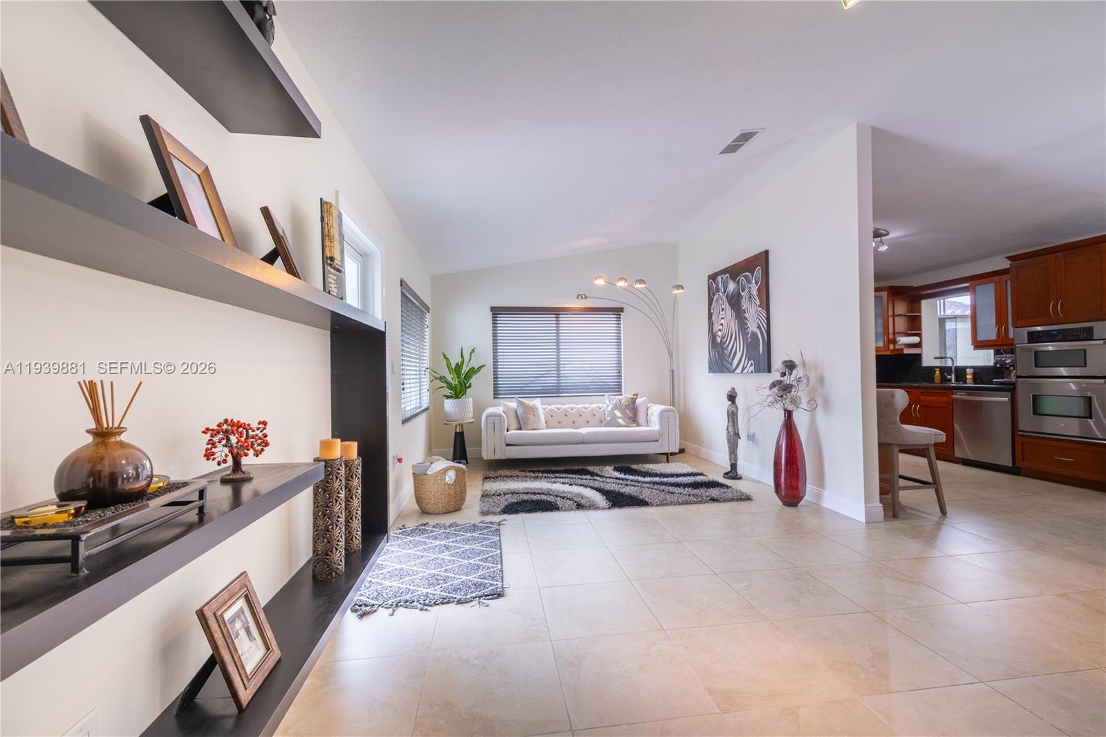 14766 Southwest 81st Street Miami, FL 33193 - Photo 1 of 39 a living room with furniture and a flat screen tv