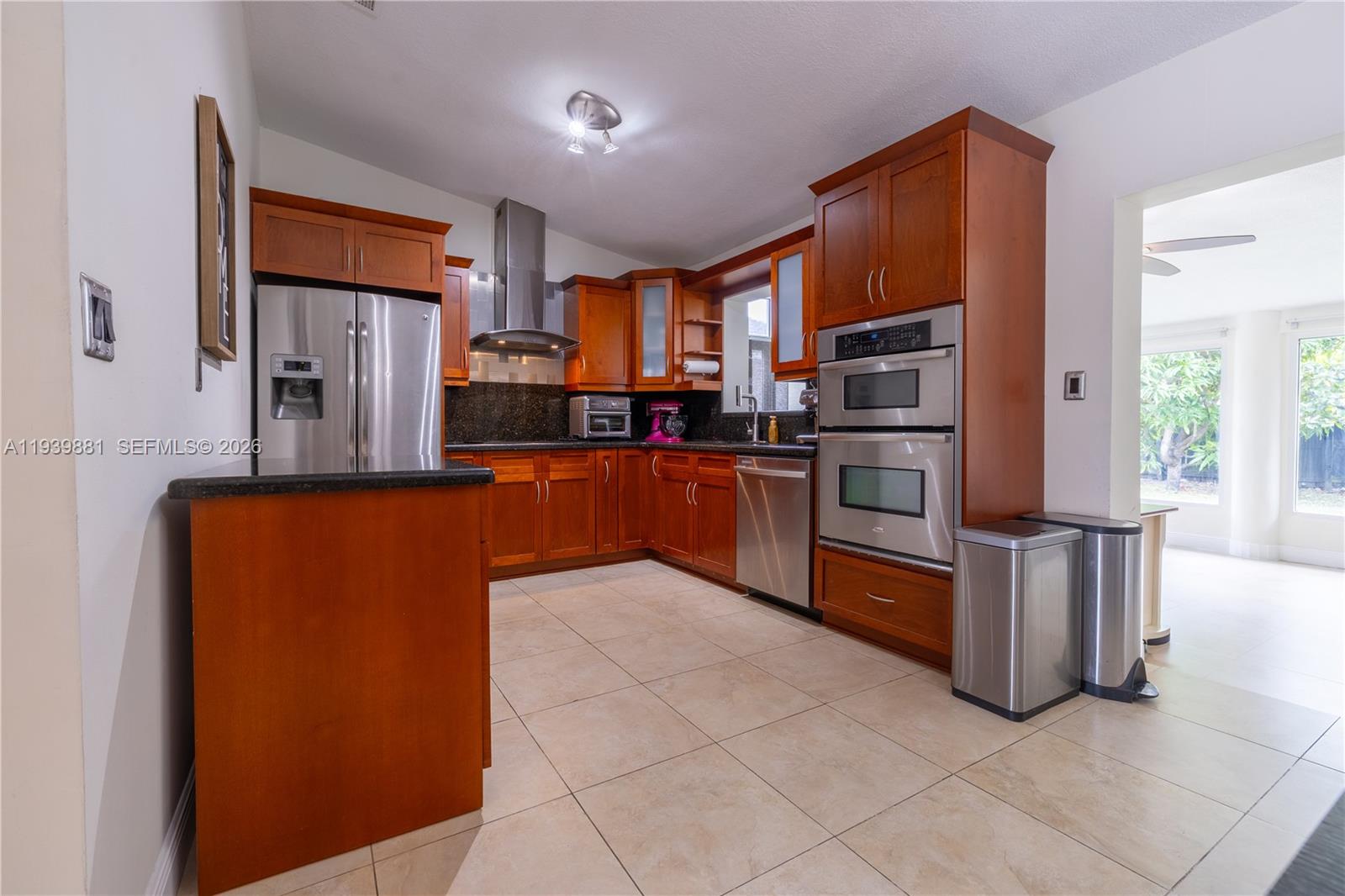 14766 Southwest 81st Street Miami, FL 33193 - Photo 11 of 39 a kitchen with stainless steel appliances granite countertop a refrigerator and a stove top oven