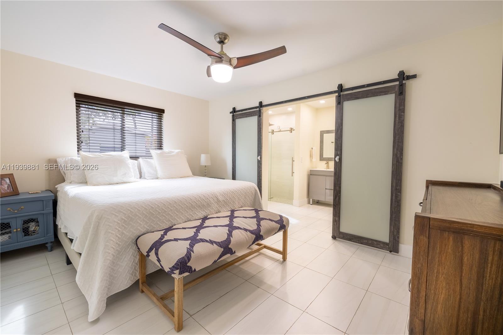 14766 Southwest 81st Street Miami, FL 33193 - Photo 18 of 39 a bedroom with a bed mirror and window