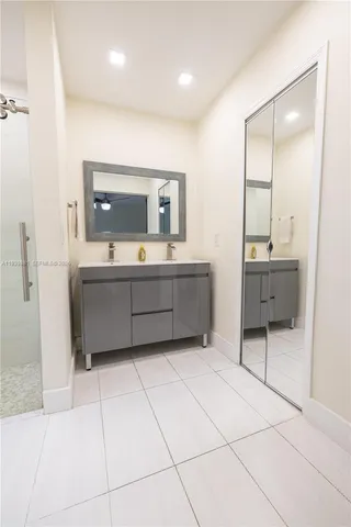 a bathroom with a sink a vanity and mirror