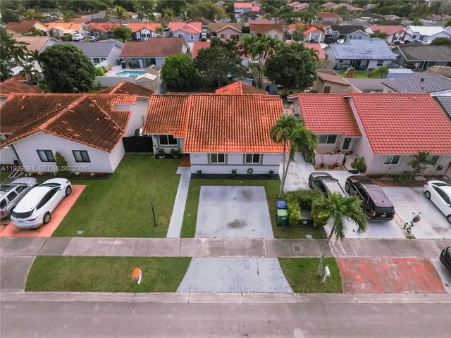an aerial view of a house with garden space and lake view