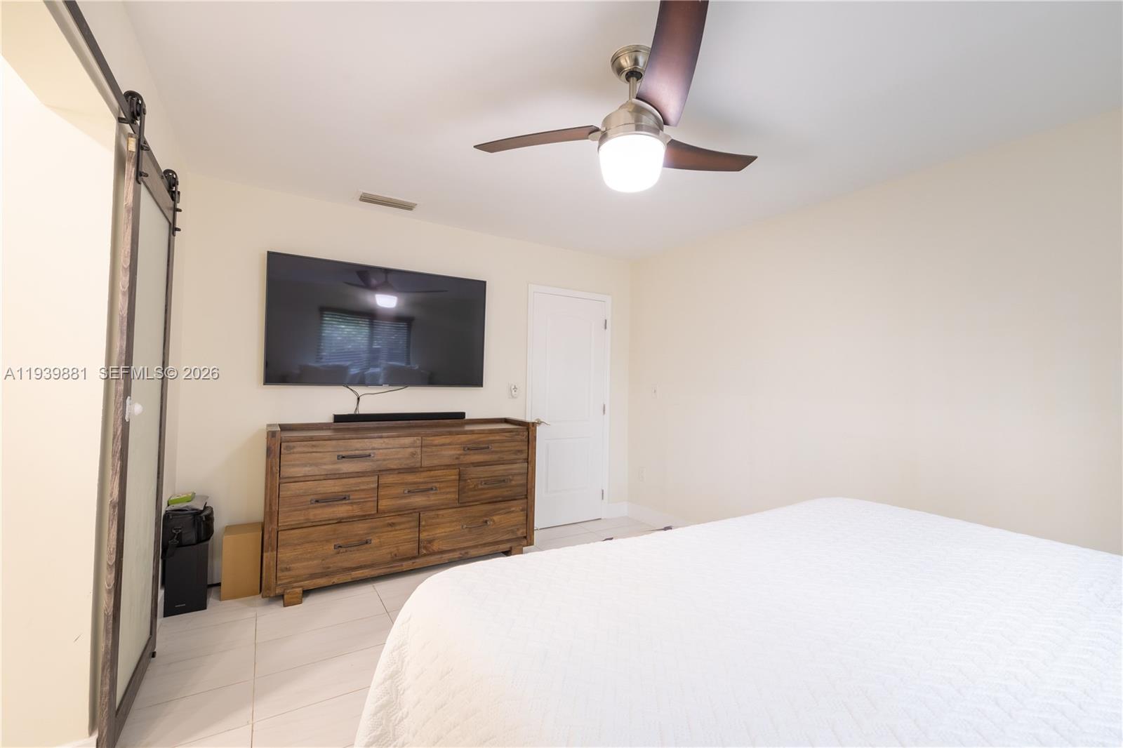 14766 Southwest 81st Street Miami, FL 33193 - Photo 21 of 39 a bedroom with a bed and a flat screen tv
