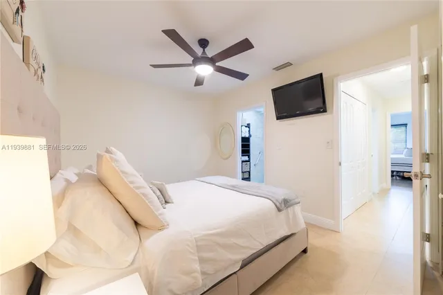 a bedroom with a bed and a flat screen tv