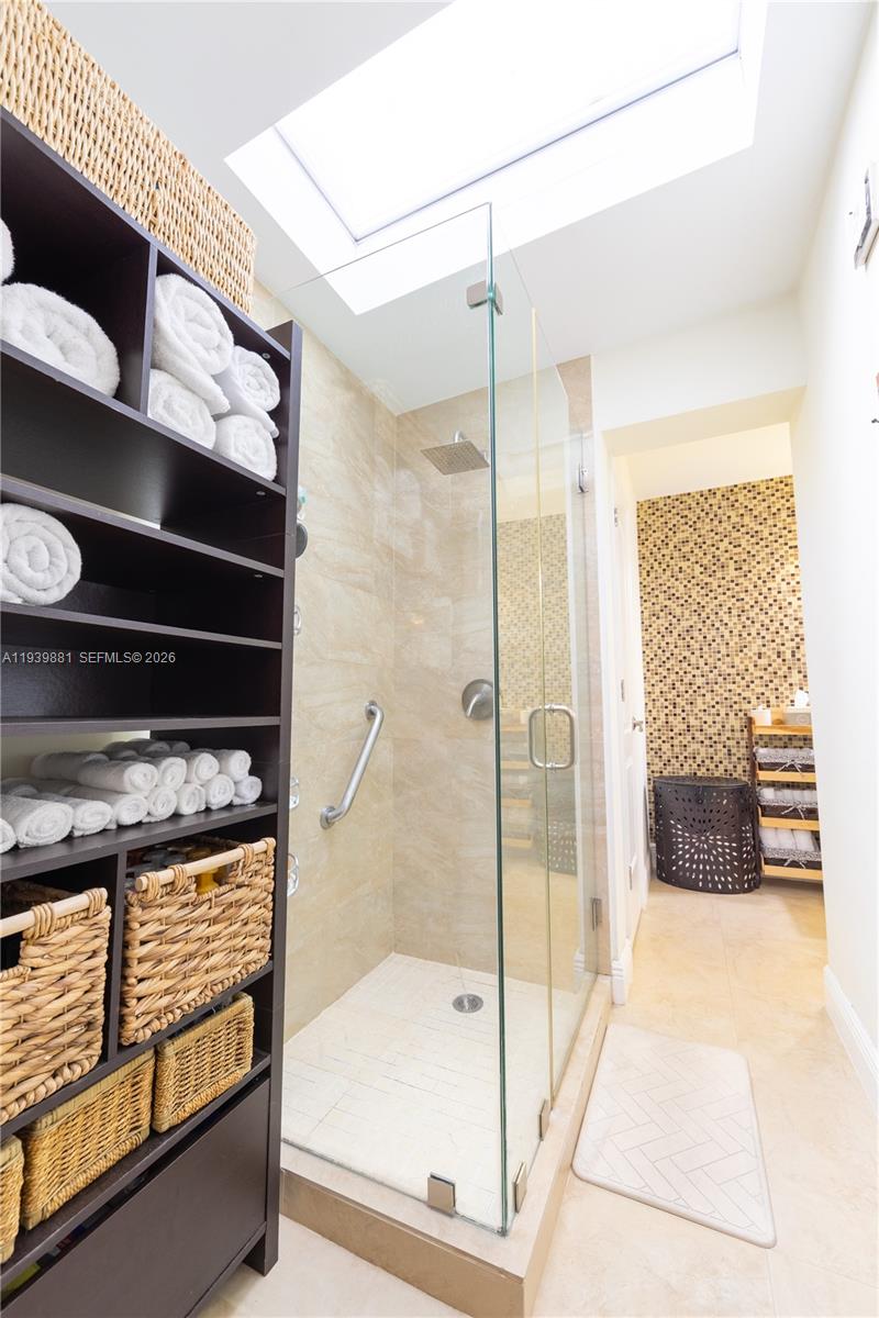 14766 Southwest 81st Street Miami, FL 33193 - Photo 24 of 39 a bathroom with a glass shower door and a bathtub