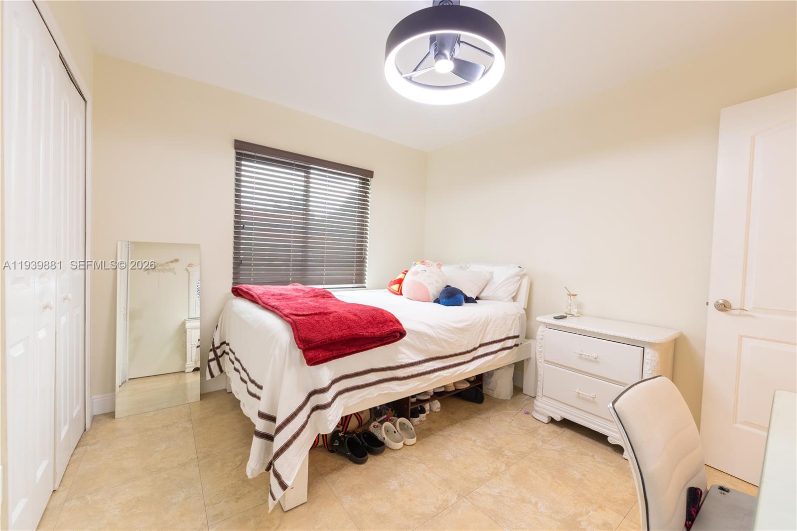 14766 Southwest 81st Street Miami, FL 33193 - Photo 27 of 39 a bedroom with a bed and a chandelier