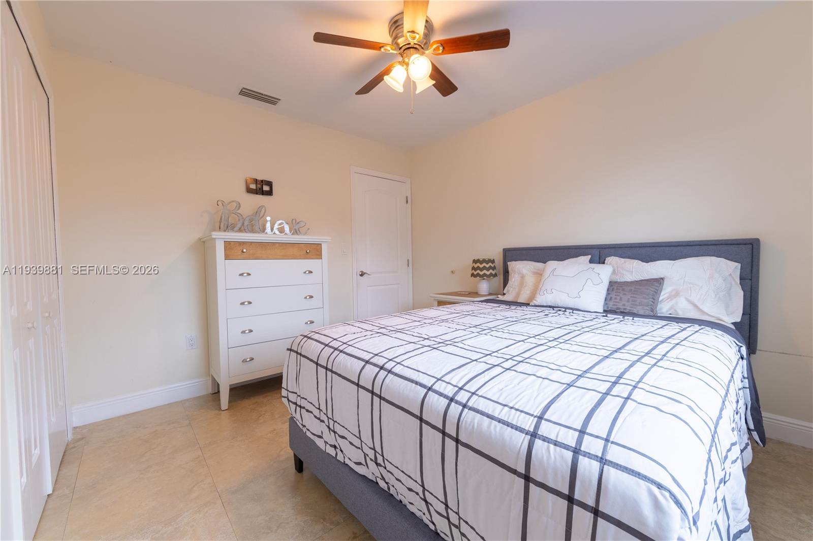 14766 Southwest 81st Street Miami, FL 33193 - Photo 29 of 39 a bedroom with a bed and a chandelier