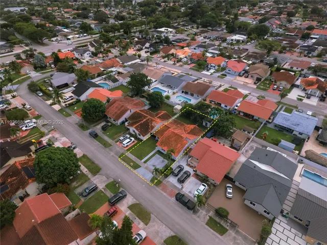 an aerial view of residential houses with outdoor space