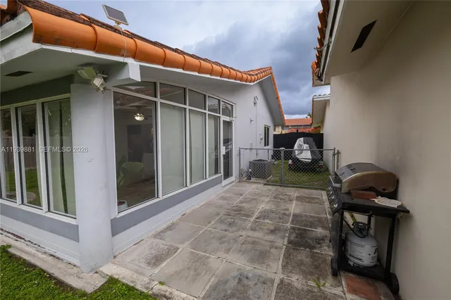 a view of a house with backyard and porch