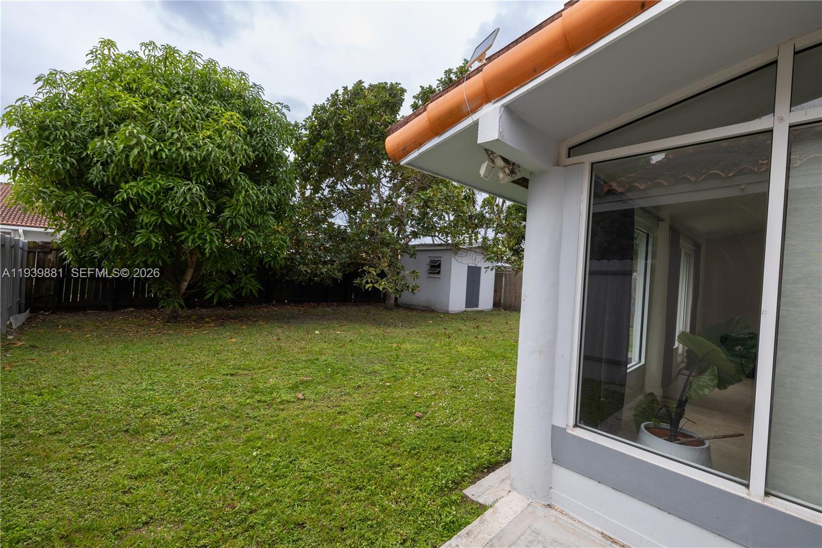 14766 Southwest 81st Street Miami, FL 33193 - Photo 38 of 39 a backyard of a house with lots of green space