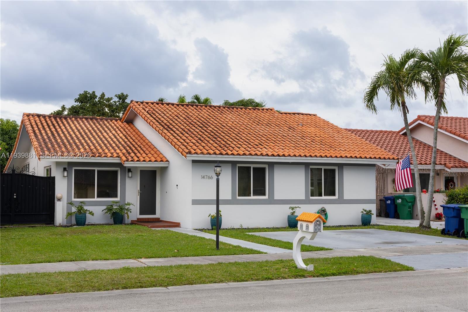 14766 Southwest 81st Street Miami, FL 33193 - Photo 4 of 39 a front view of a house with a yard