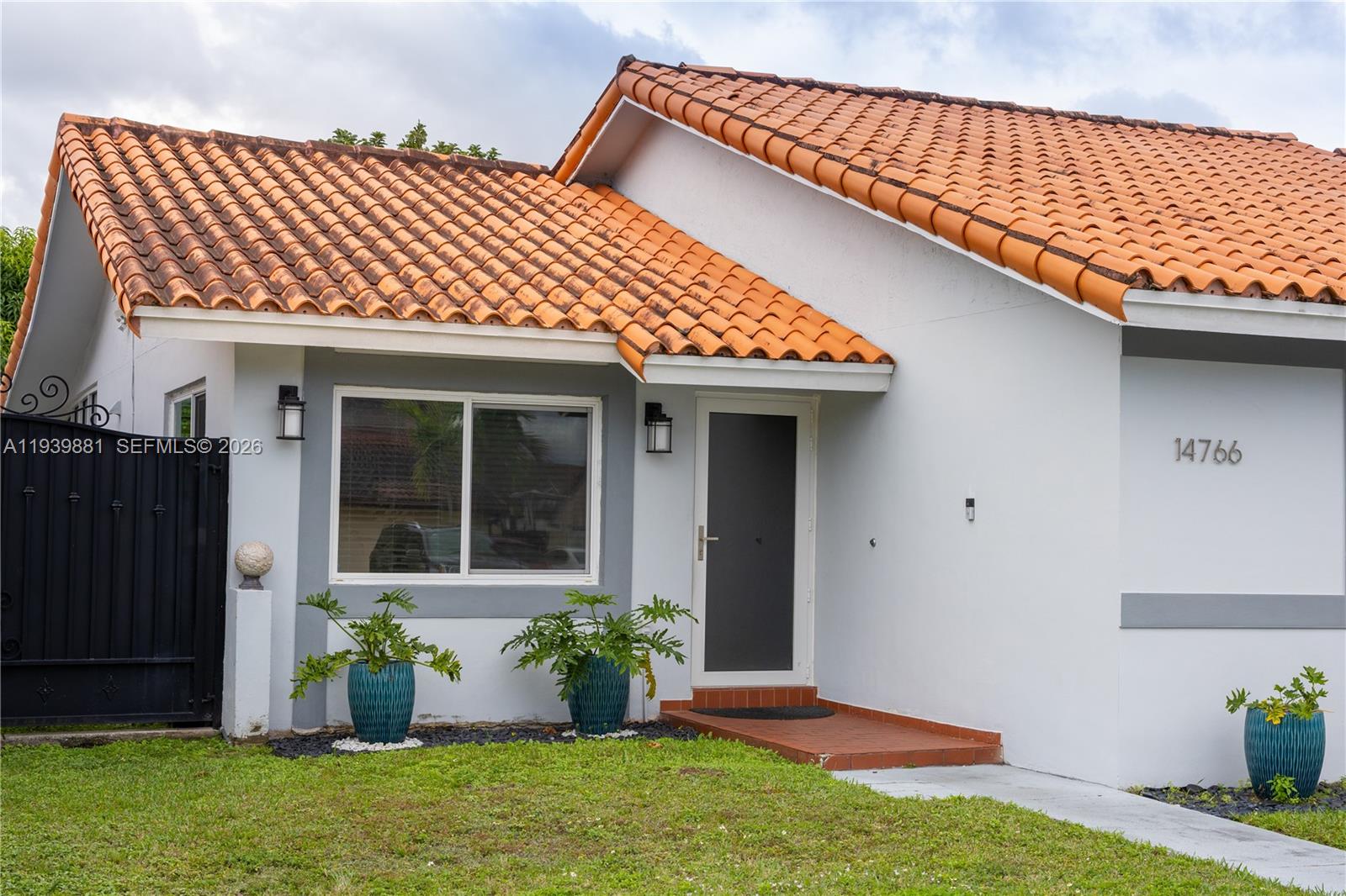 14766 Southwest 81st Street Miami, FL 33193 - Photo 6 of 39 a front view of a house with garden